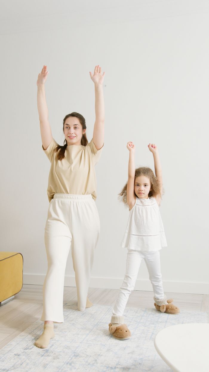 Crafting Captivating Headlines: Your awesome post title goes here A mother and daughter practice yoga indoors, promoting wellness and a healthy lifestyle.